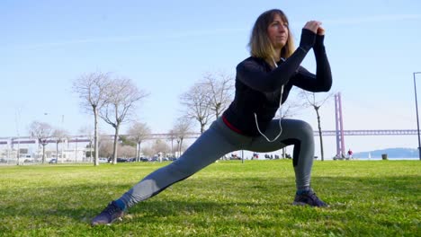 Athletic-girl-in-sportswear-working-out-in-park